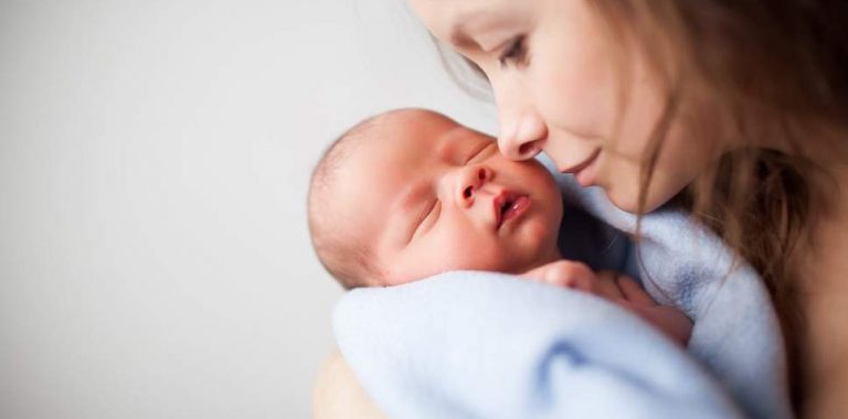 newborn baby woman holding